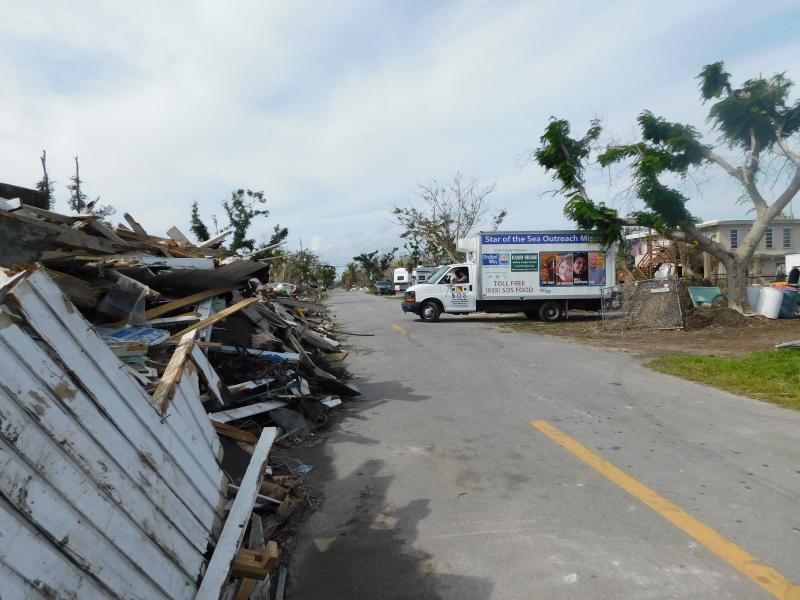 Here SOS delivers fresh mattresses in a devastated neighborhood.